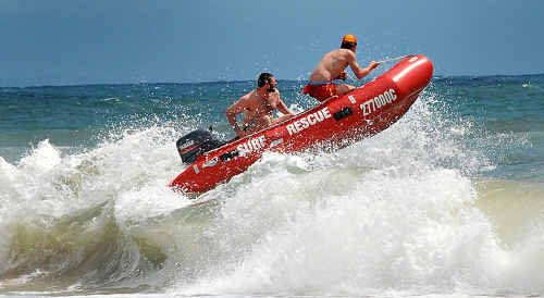 Rainbow Beach Club captain Shane Handy pilots the IRB over the waves. Rainbow Beach Club captain Shane Handy pilots the IRB over the waves.